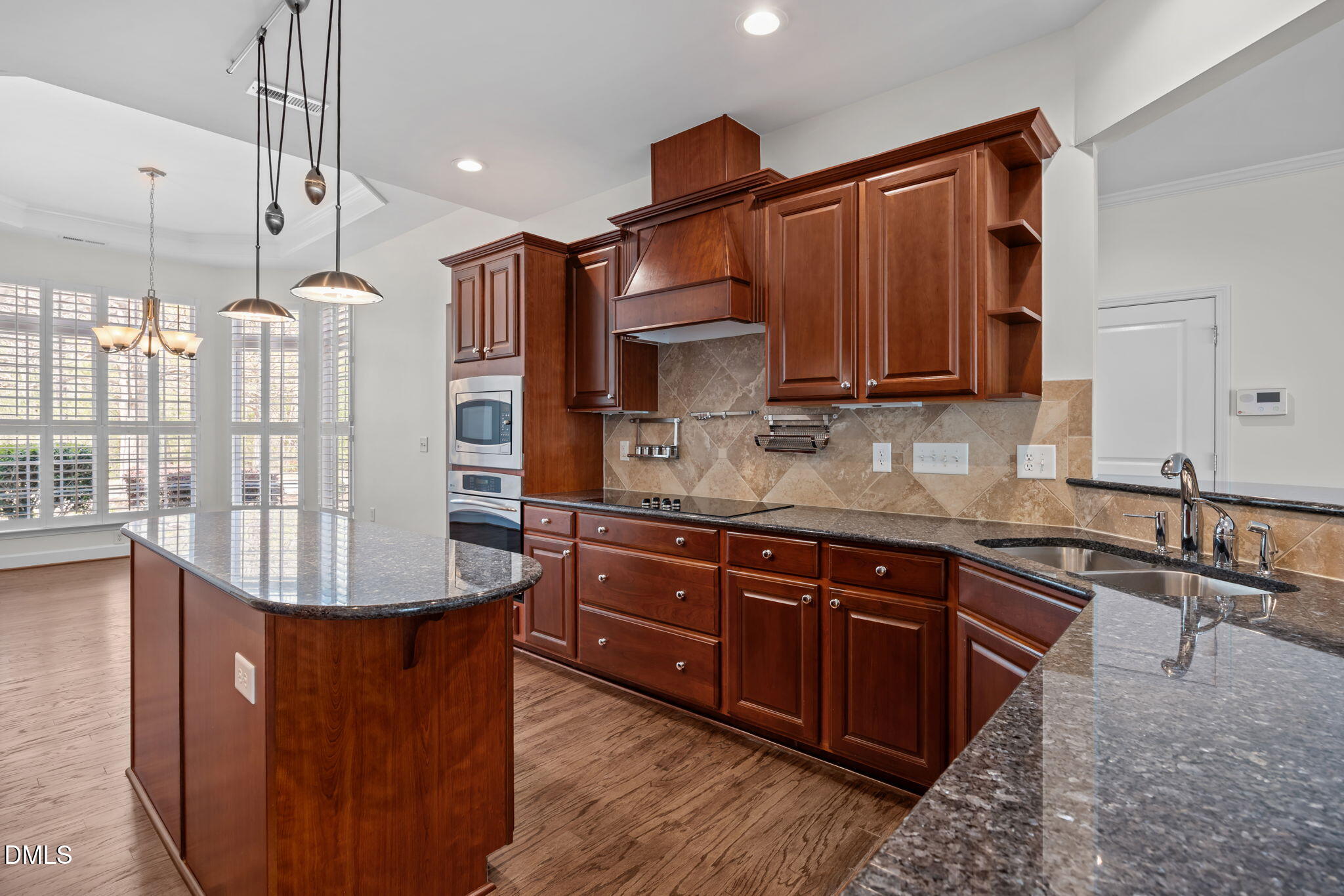 268 Beckingham Loop Cary, NC 27519 - Photo 10 of 36 a kitchen with stainless steel appliances granite countertop a stove a sink dishwasher and a refrigerator with wooden floor