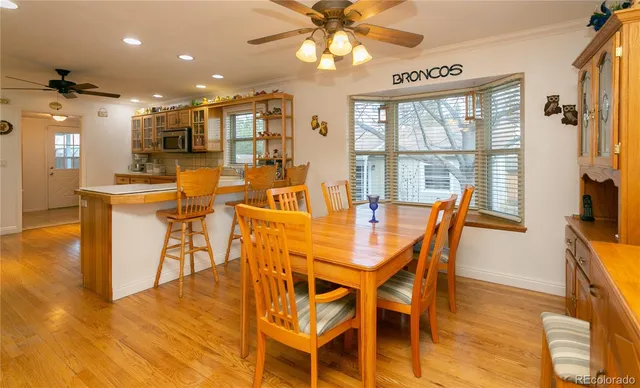 a view of a dining room with furniture a chandelier and wooden floor
