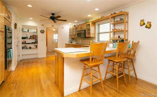 a view of a dining room with furniture and a kitchen
