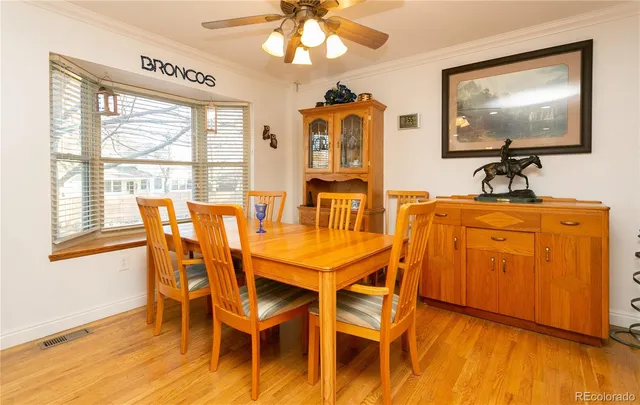 a dining room with furniture and wooden floor