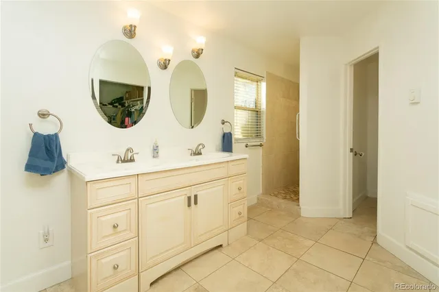 a bathroom with a double vanity sink mirror and