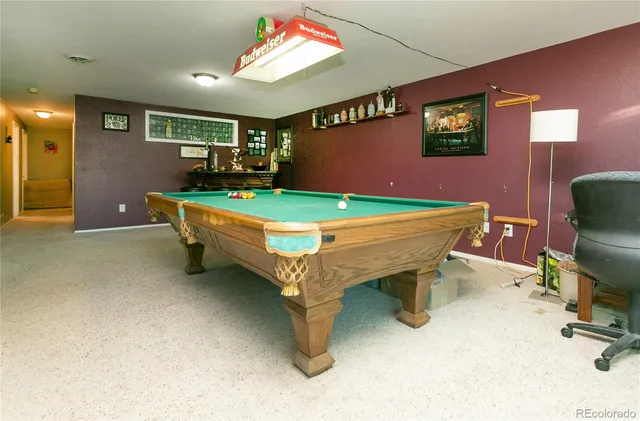 a room with furniture and pool table