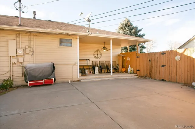 a backyard of a house with barbeque oven table and chairs