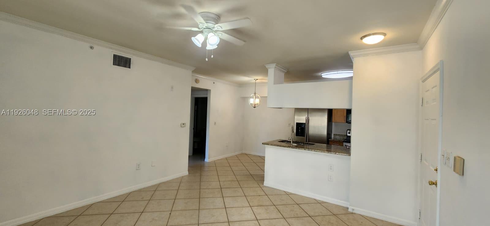 6505 Emerald Dunes Drive, Unit 307 West Palm Beach, FL 33411 - Photo 12 of 17 a kitchen with granite countertop a sink a counter space and cabinets