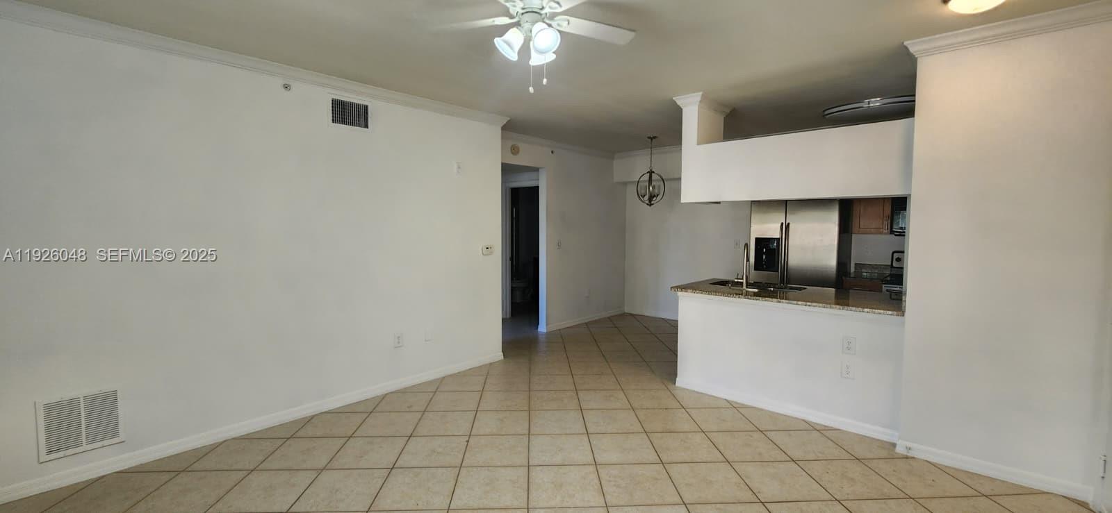 6505 Emerald Dunes Drive, Unit 307 West Palm Beach, FL 33411 - Photo 13 of 17 a kitchen with granite countertop a stove a sink and a refrigerator