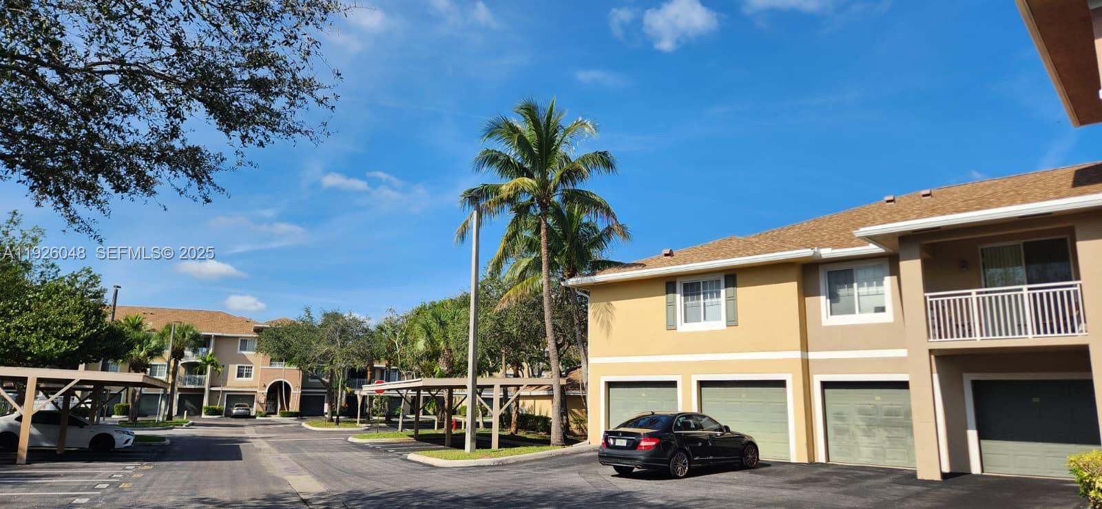 6505 Emerald Dunes Drive, Unit 307 West Palm Beach, FL 33411 - Photo 17 of 17 a car parked in front of a building