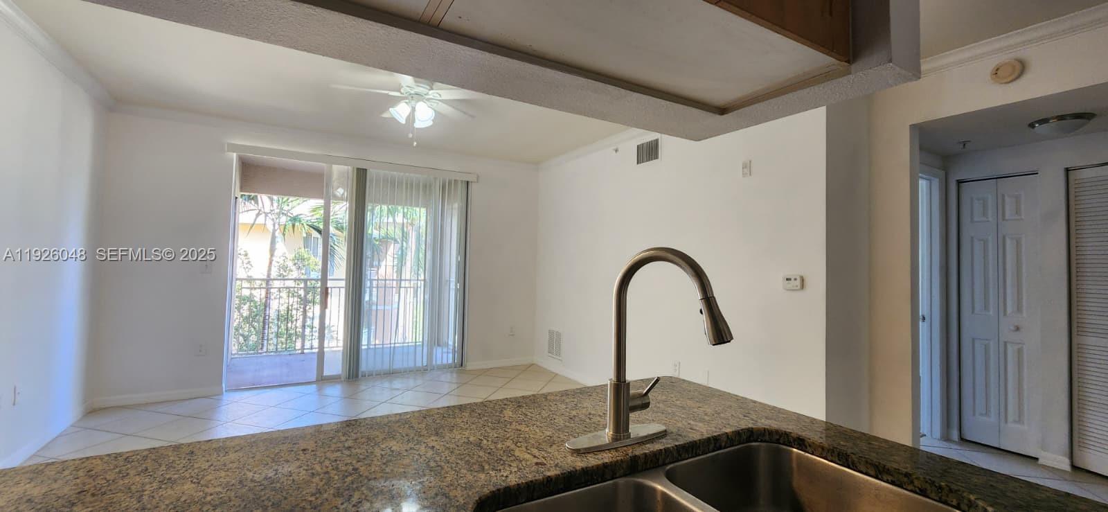 6505 Emerald Dunes Drive, Unit 307 West Palm Beach, FL 33411 - Photo 2 of 17 a close view of a sink a faucet and appliance in the patio