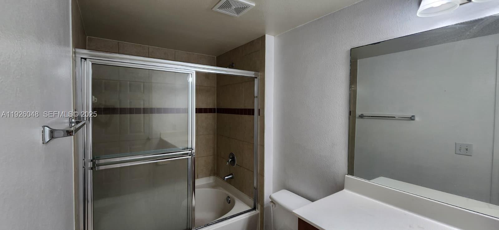 6505 Emerald Dunes Drive, Unit 307 West Palm Beach, FL 33411 - Photo 4 of 17 a bathroom with a glass shower door