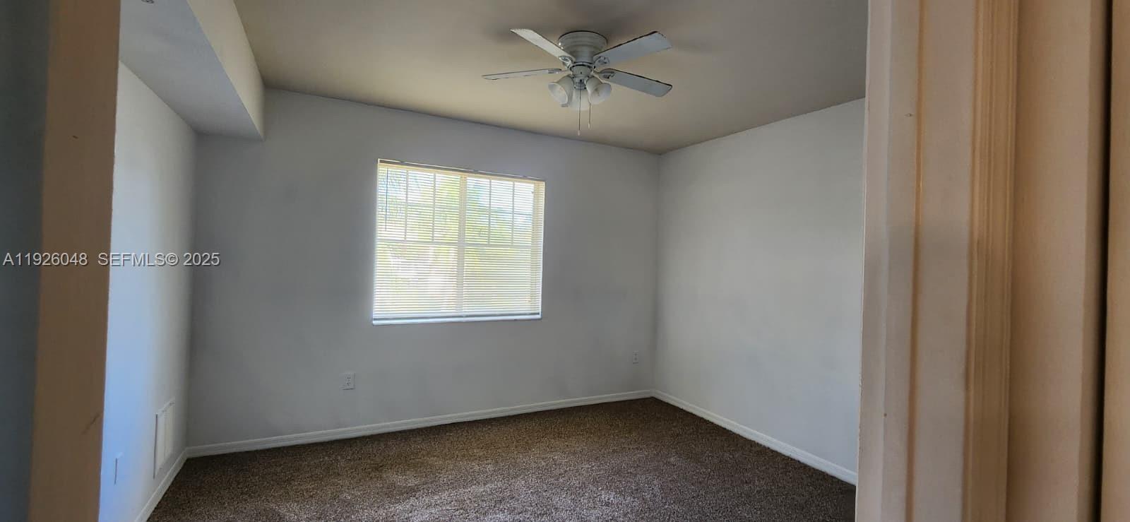 6505 Emerald Dunes Drive, Unit 307 West Palm Beach, FL 33411 - Photo 7 of 17 a view of an empty room with a window