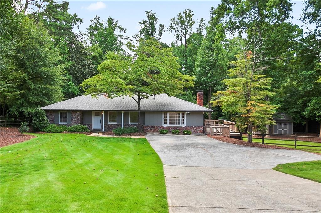 4000 Lower Roswell Road Marietta, GA 30068 - Photo 1 of 25 a front view of a house with garden