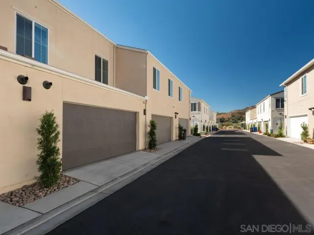 a city view with tall buildings and cars parked on road