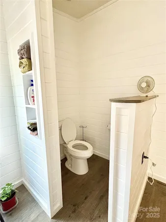a bathroom with a toilet and a shower curtain