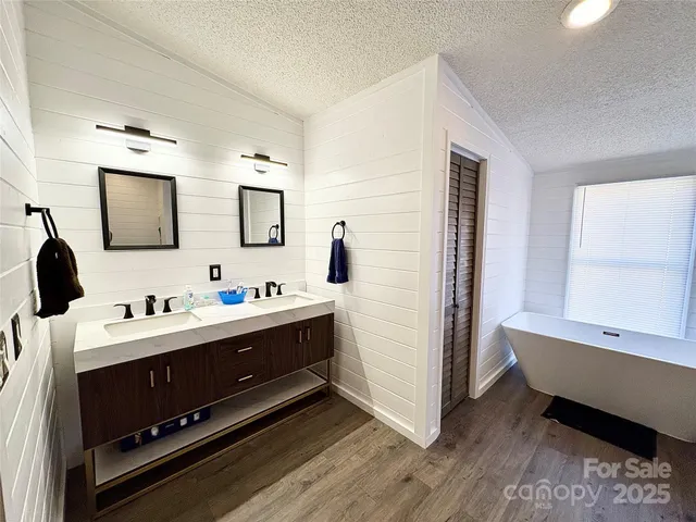 a spacious bathroom with a tub and shower