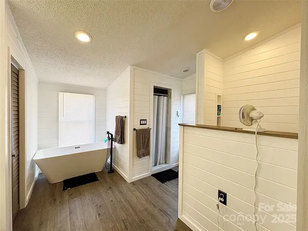 a spacious bathroom with a tub and shower