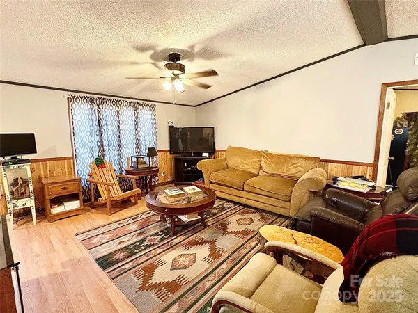 a living room with furniture fireplace and a flat screen tv