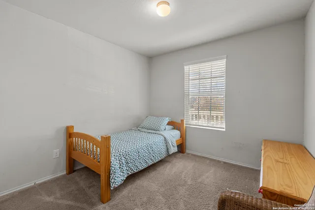 a bedroom with a bed and a chair