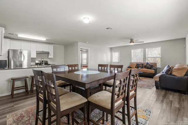 a view of a dining room with furniture and wooden floor