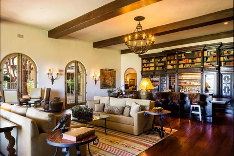 a living room with fireplace furniture and wooden floor