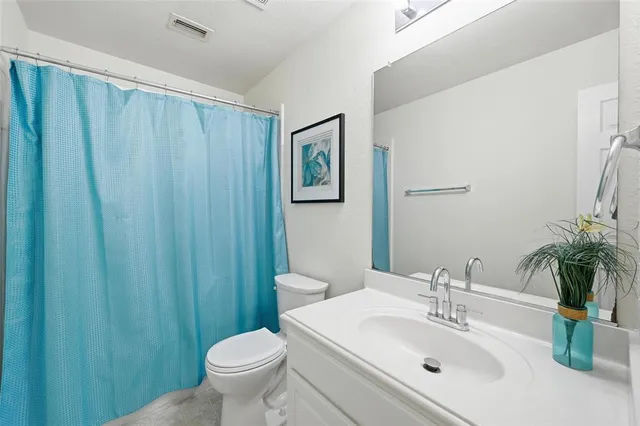 a bathroom with a toilet a sink and a mirror