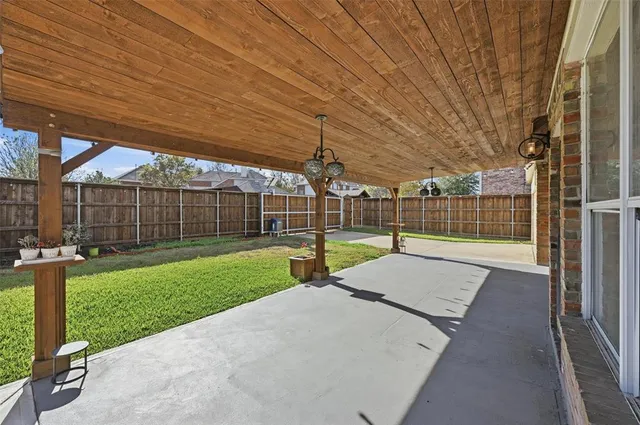 a view of a backyard with wooden fence