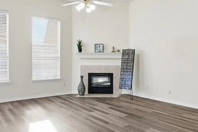 a view of an empty room with a fireplace and a window