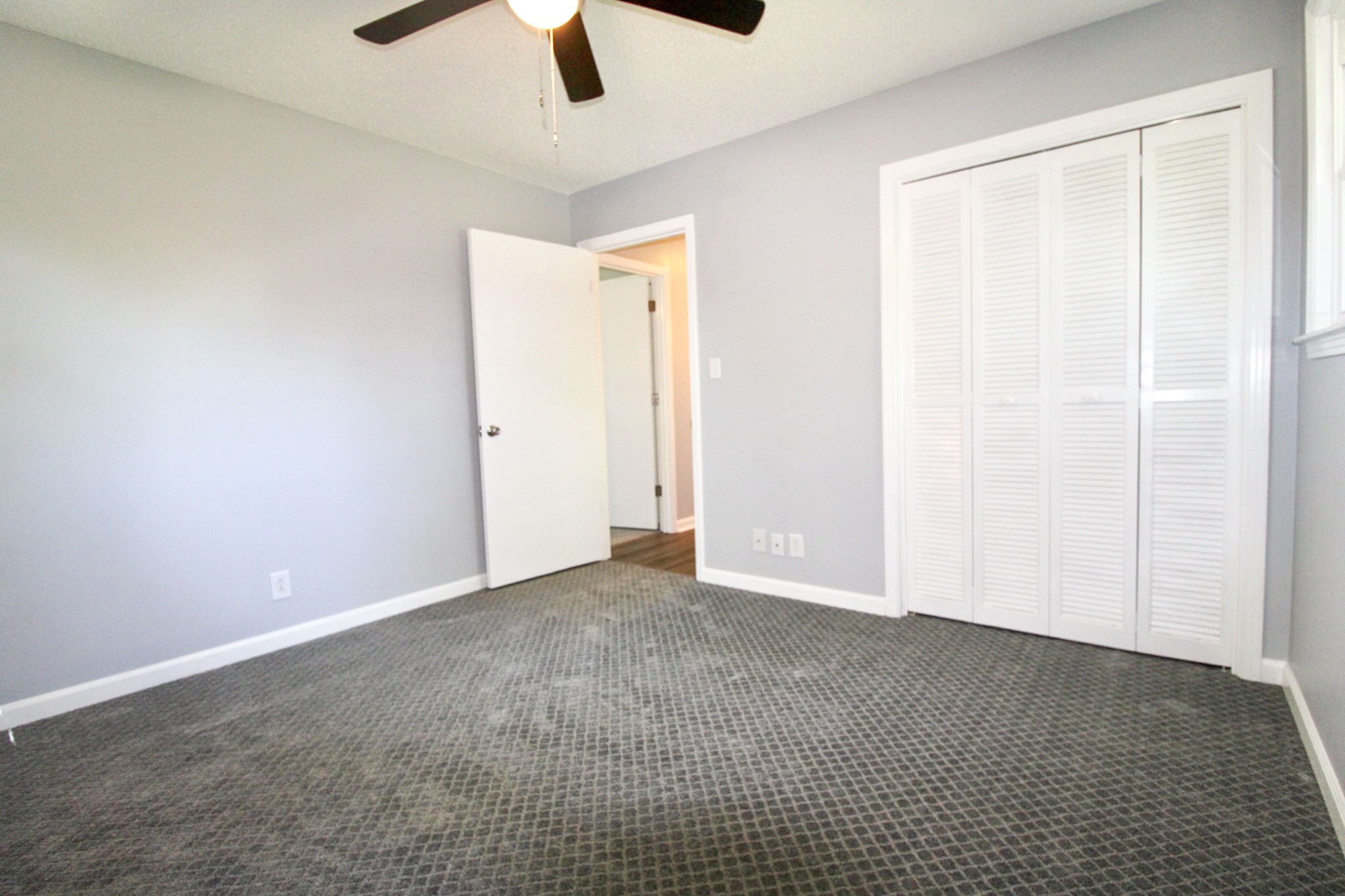 212 Cunningham Lane Clarksville, TN 37042 - Photo 12 of 19 an empty room with closet and chandelier fan