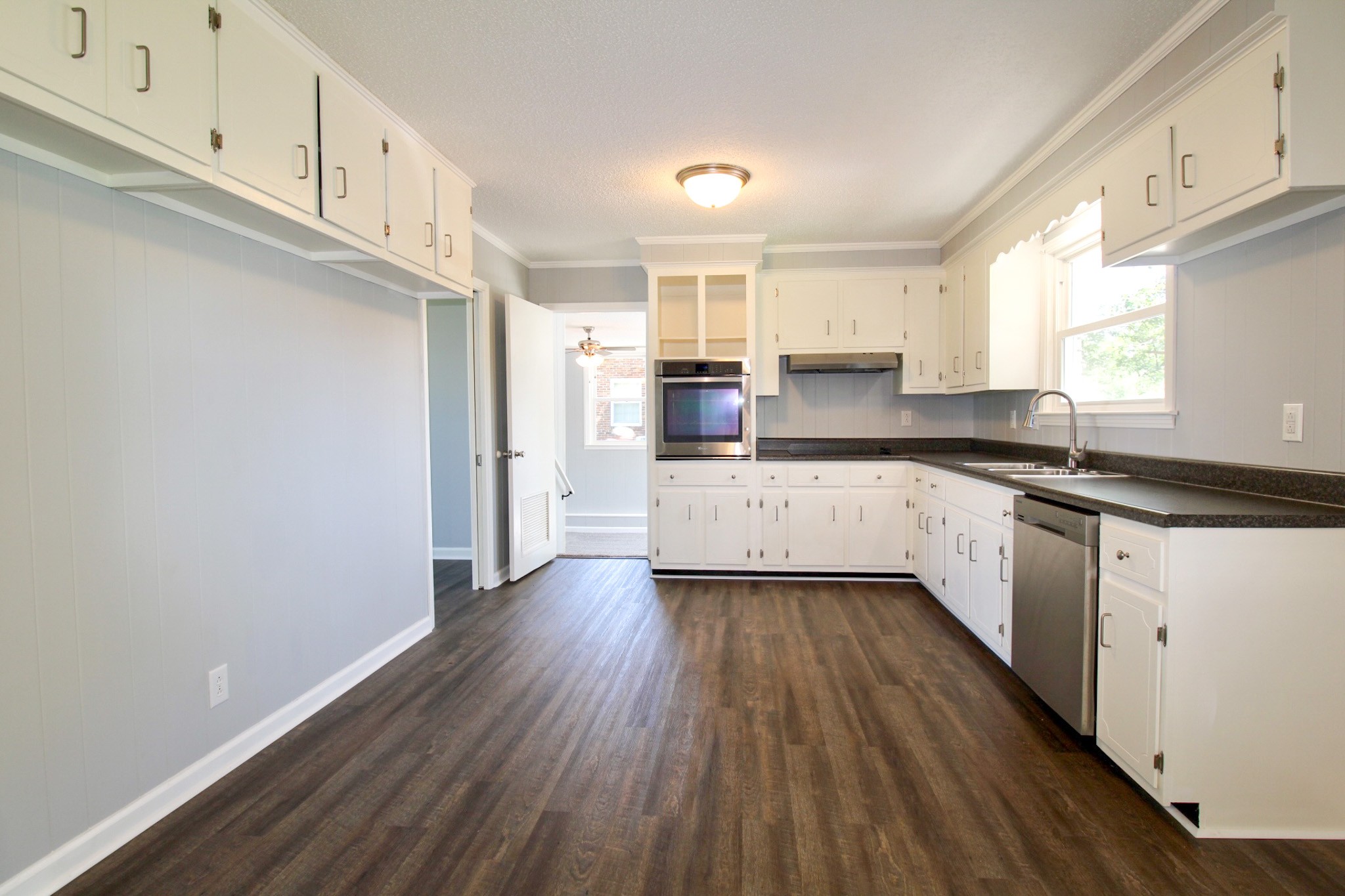 212 Cunningham Lane Clarksville, TN 37042 - Photo 6 of 19 a kitchen with granite countertop a sink cabinets stainless steel appliances and a window