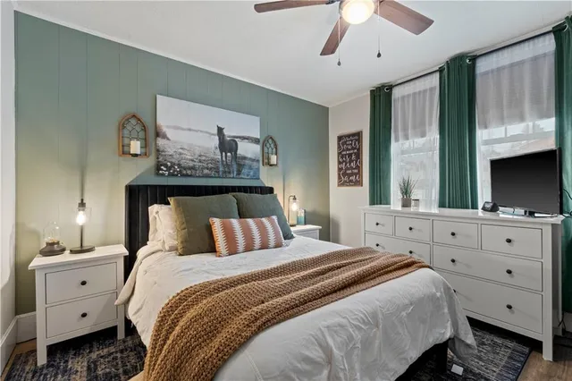 a bedroom with a bed and a flat screen tv