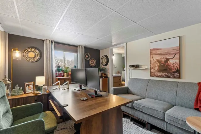 a room with a couch and a view of kitchen