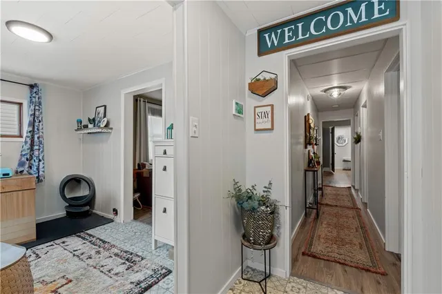 a view of an entryway with wooden floor and door
