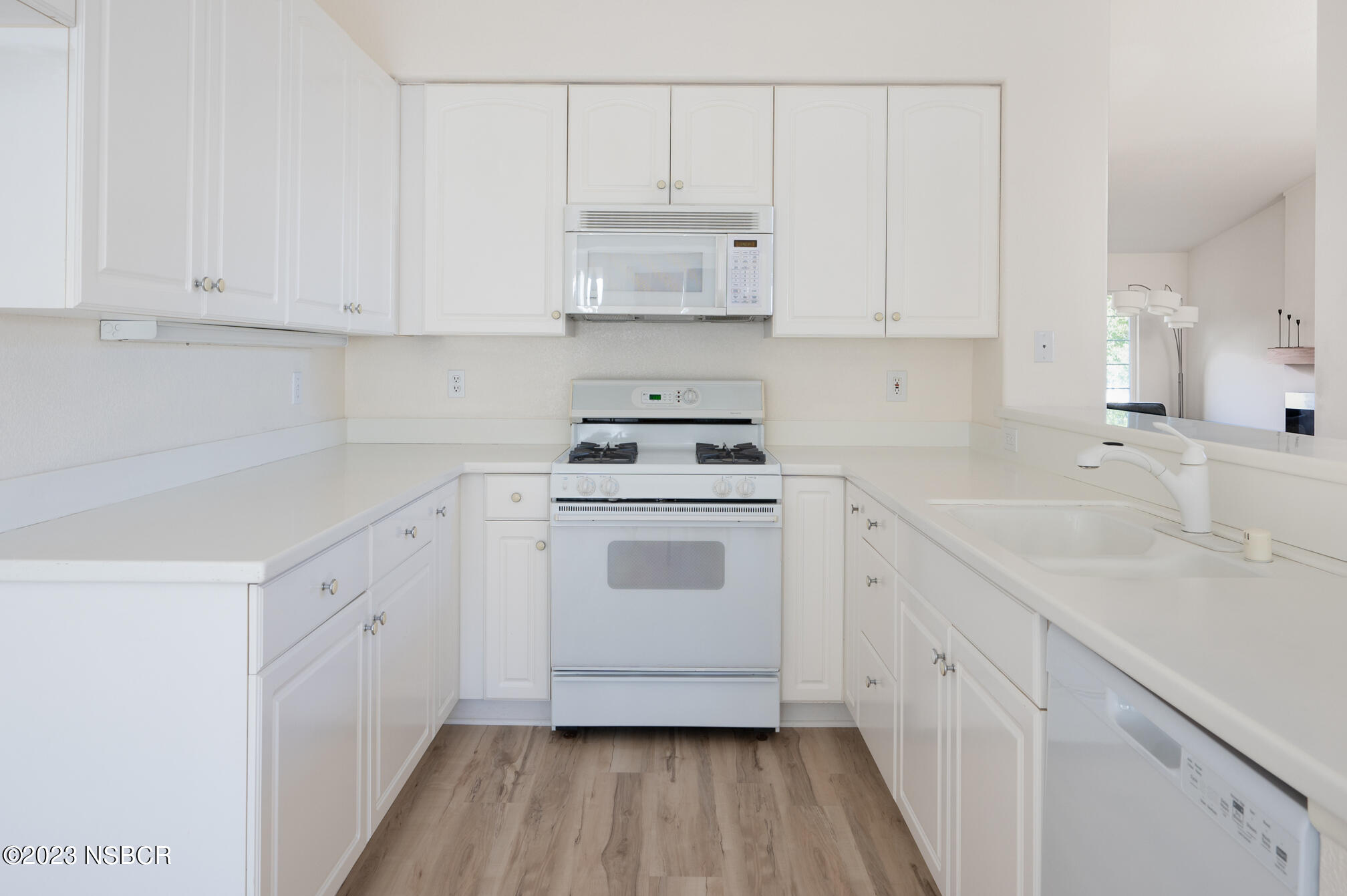 246 Ranch Road Buellton, CA 93427 - Photo 7 of 21 a kitchen with white cabinets white stainless steel appliances and sink