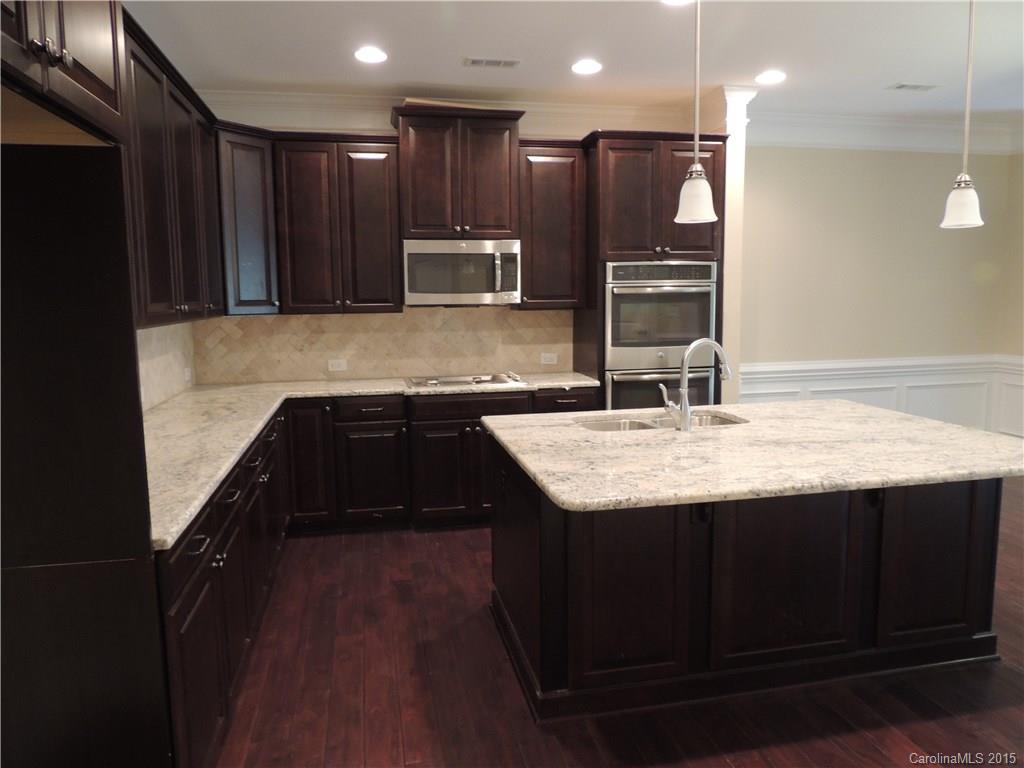 925 Ospre Lane, Unit 162 Fort Mill, SC 29708 - Photo 7 of 22 a kitchen with kitchen island granite countertop stainless steel appliances and sink
