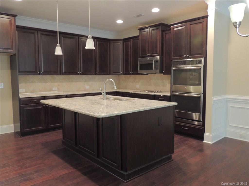 925 Ospre Lane, Unit 162 Fort Mill, SC 29708 - Photo 8 of 22 a kitchen with kitchen island a sink stainless steel appliances and cabinets