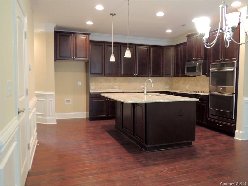 925 Ospre Lane, Unit 162 Fort Mill, SC 29708 - Photo 10 of 22 a kitchen with kitchen island a sink stainless steel appliances and cabinets