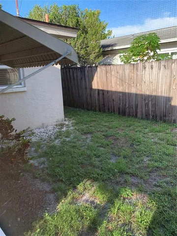 a view of a house with backyard and garage