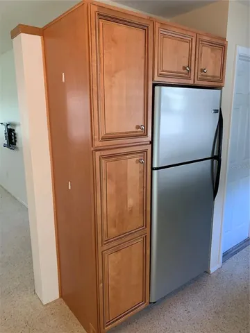 a white refrigerator freezer sitting in a kitchen