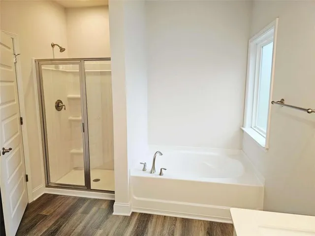 a bathroom with a bathtub and a shower