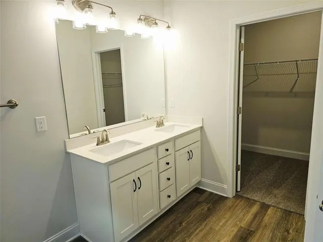 a bathroom with a double vanity sink and mirror