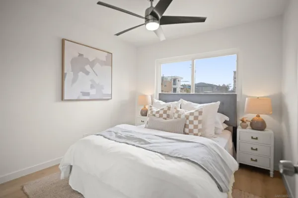 a bed room with a bed and a painting on the wall