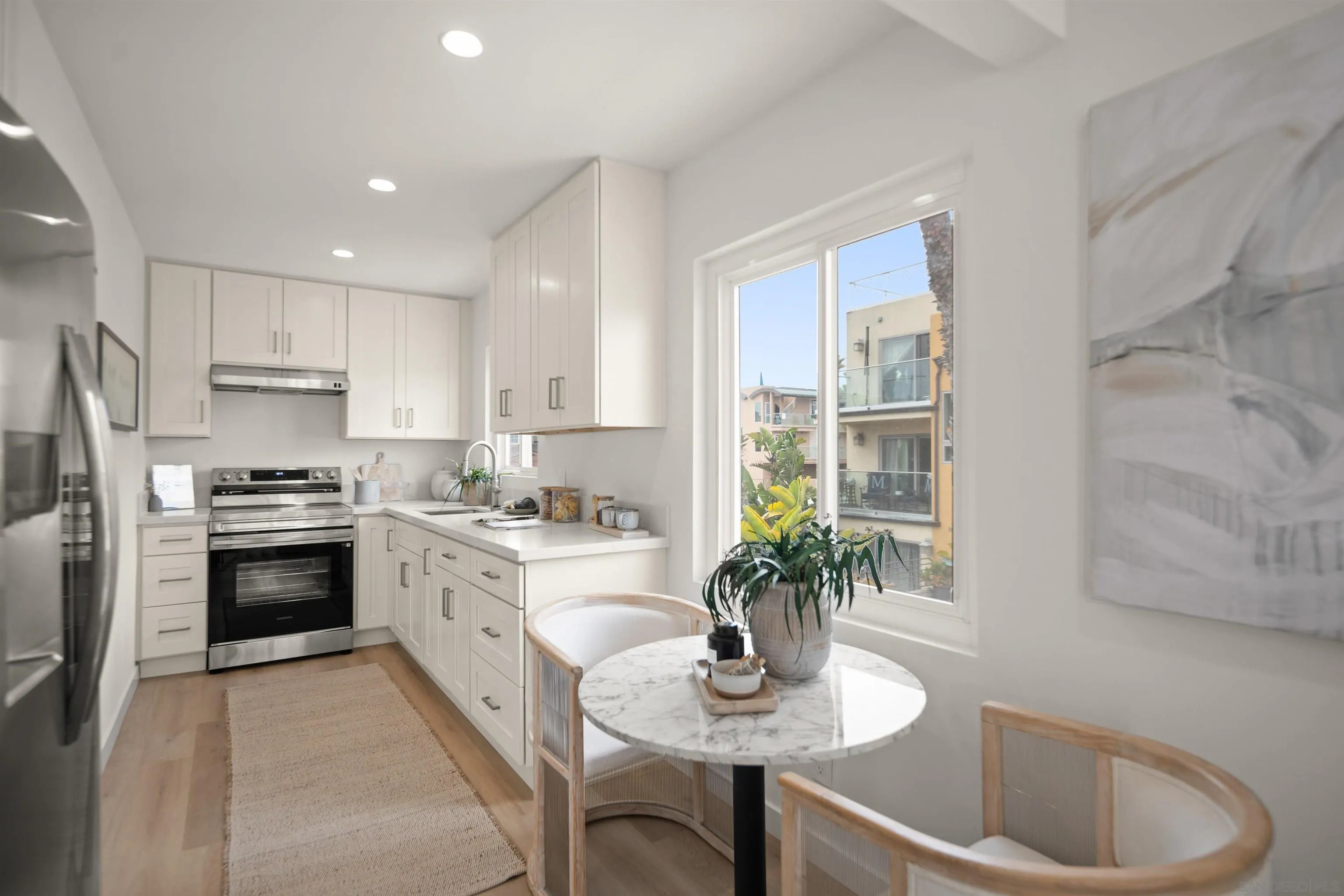 801-809 Liverpool Court San Diego, CA 92109 - Photo 10 of 24 a kitchen with a refrigerator and a white cabinets