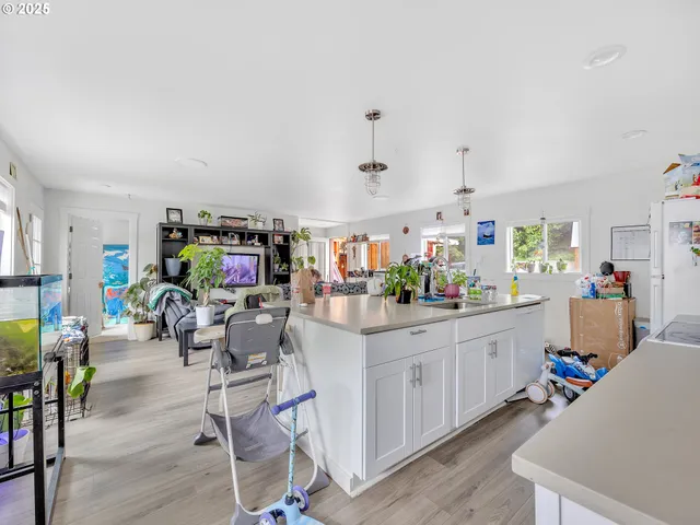 a room with furniture and a kitchen view