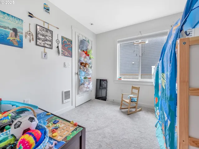 a bedroom with furniture and a book shelf