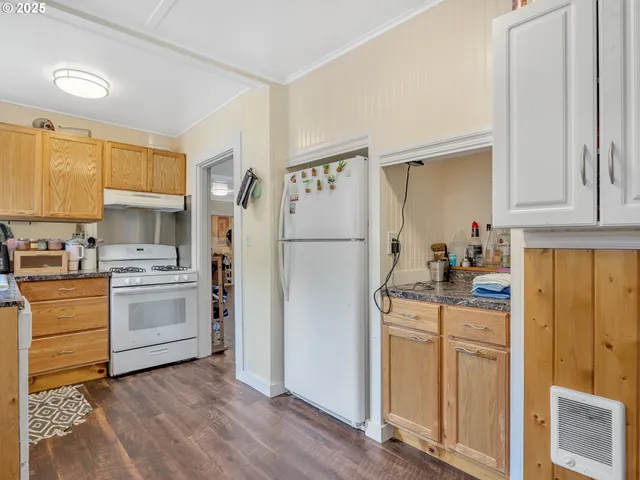 a kitchen with a refrigerator stove and white cabinets