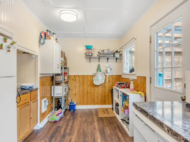 a kitchen with a stove a sink and a refrigerator