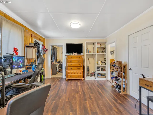 a room with furniture a flat screen tv and a window