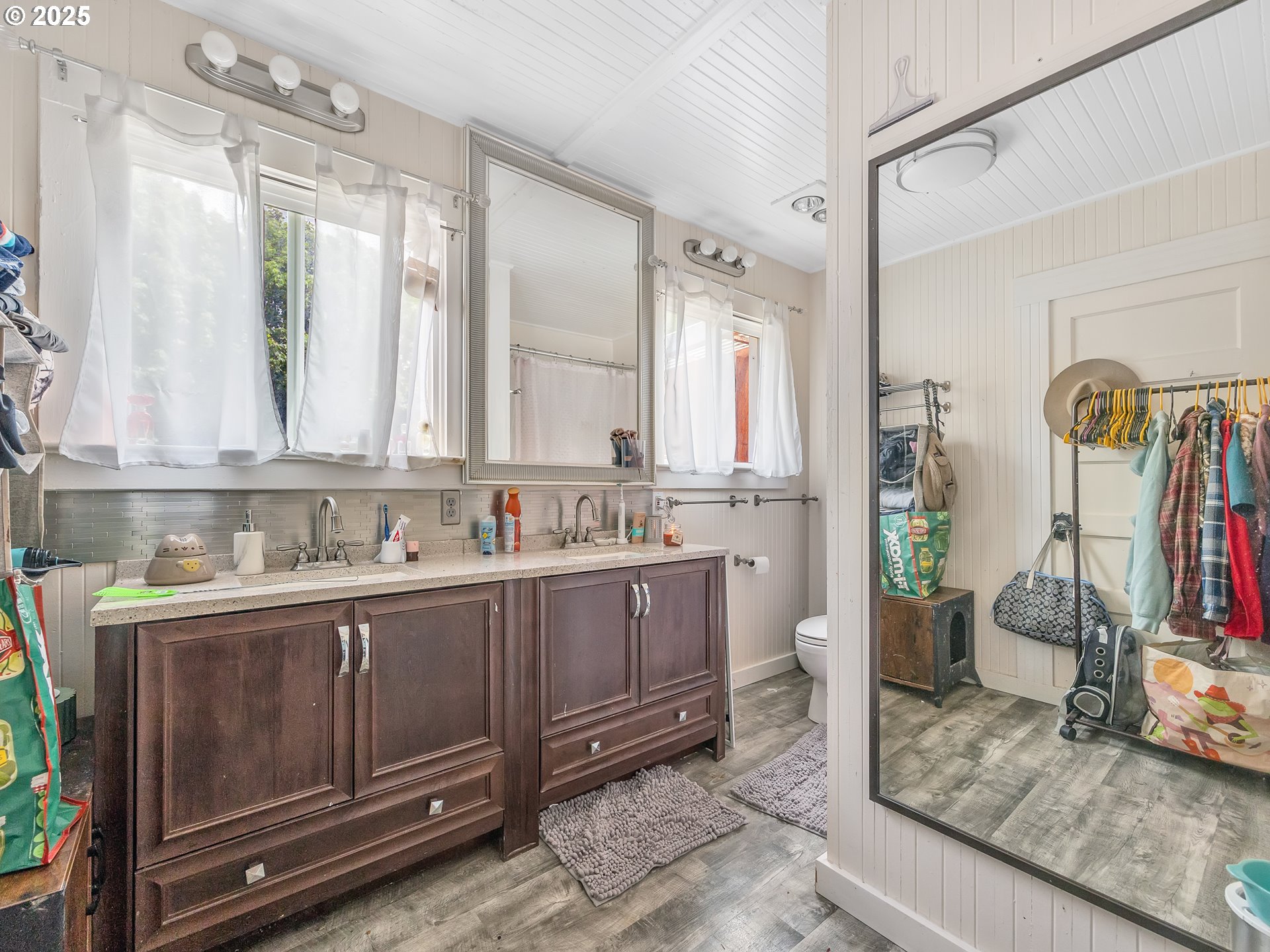 3379 North Highway 101 Warrenton, OR 97146 - Photo 29 of 34 a bathroom with a granite countertop sink a toilet and a mirror