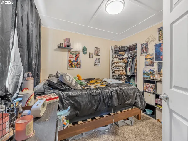 a bedroom with a bed and a dresser