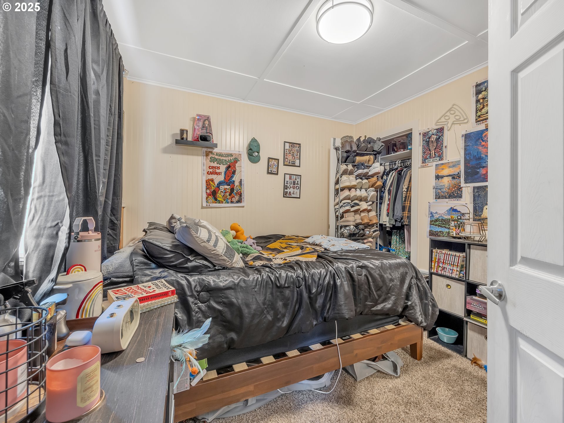 3379 North Highway 101 Warrenton, OR 97146 - Photo 30 of 34 a bedroom with a bed and a book shelf