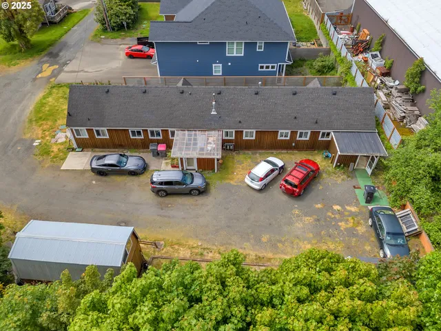 an aerial view of a house with garden space and street view