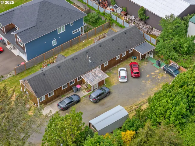 an aerial view of a tennis ground and a cars park